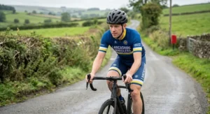 A British club cyclist wearing an affordable road cycling helmet under £100 while riding along a rural country lane in the UK.