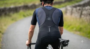 Rear view of a cyclist showing the high-stretch mesh straps on a pair of high-performance men's bib shorts.