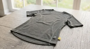Illustration of a men's athletic-fit merino cycling base layer featuring flatlock stitching