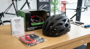 An overview of a value-for-money road cycling helmet under £100 unboxed with its user manual and spare internal padding sets.