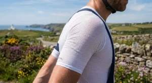 Close-up of a short-sleeve summer cycling base layer showing breathable open-mesh fabric designed for sweat management.