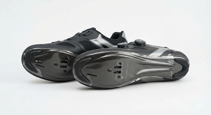 Pair of high-performance clipless road cycling shoes with carbon soles displayed on a clean white background.