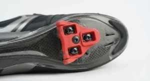 Close-up view of a standard three-bolt cleat mechanism fitted to the underside of clipless road cycling shoes.
