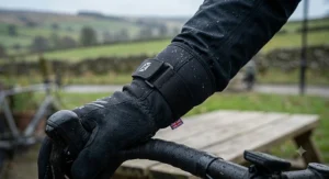 Detail illustration showing the extended neoprene wrist cuff and adjustable strap on a waterproof cycling glove