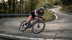 Rider leaning into a tight corner utilizing Look Keo cleats for racing on a countryside circuit