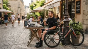 A cyclist pausing for a coffee outside a British cafe in SPD cleats for commuting