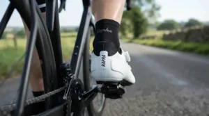 Reinforced heel cup design on stiff carbon sole road shoes for racing for secure foot retention